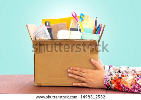 closeup woman hand holding tools of school for donation or back to school concept