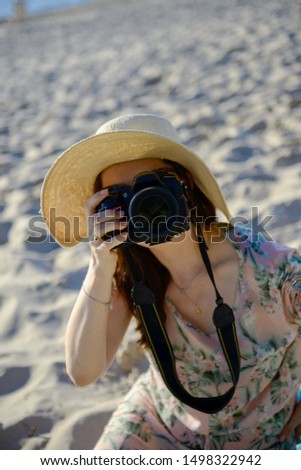 professional woman photographer on the beach, summer time