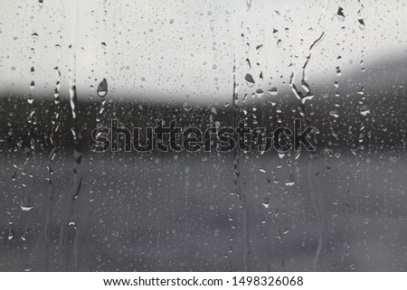 Drops of water on the glass. Background of water drops flowing down the glass