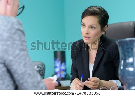 funeral worker talking to sad woman Royalty-Free Stock Photo #1498333058