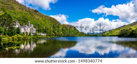 Panorama of Kylemore Abbey, beautiful castle like abbey reflected in lake at the foot of a mountain. Benedictine monastery, in Connemara, Ireland Royalty-Free Stock Photo #1498340774