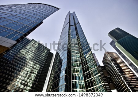 Office and residential skyscrapers on bright sun and clear blue sunset sky background. Commercial real estate. Modern business city district. Office buildings exterior. Financial city district.  Royalty-Free Stock Photo #1498372049