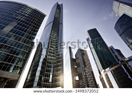 Office and residential skyscrapers on bright sun and clear blue sunset sky background. Commercial real estate. Modern business city district. Office buildings exterior. Financial city district.  Royalty-Free Stock Photo #1498372052