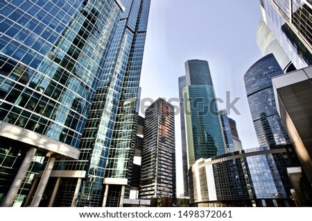 Office and residential skyscrapers on bright sun and clear blue sunset sky background. Commercial real estate. Modern business city district. Office buildings exterior. Financial city district.  Royalty-Free Stock Photo #1498372061