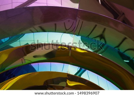 Circular arcs. Metal and ripple glass elements of modern architecture. Close-up photo of hi-tech building featuring colorful geomteric structure or fragmented rings.