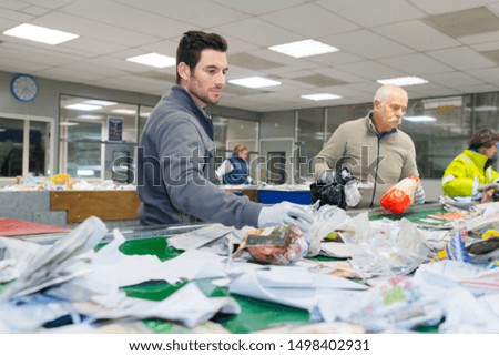 two workers are separating waste