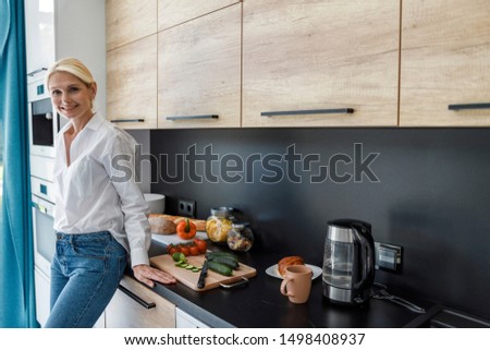 Smiling pretty female ready to cook stock photo