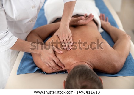 Close up of massage therapist doing rehab massage stock photo