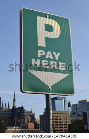 City pay here parking sign