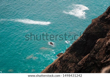 Beautiful beach with a large rocky cliff