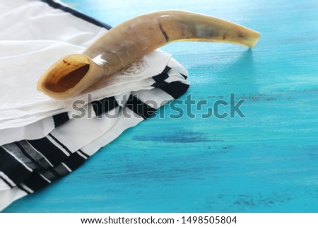 religion image of shofar (horn) on white prayer talit. Rosh hashanah (jewish New Year holiday), Shabbat and Yom kippur concept Royalty-Free Stock Photo #1498505804