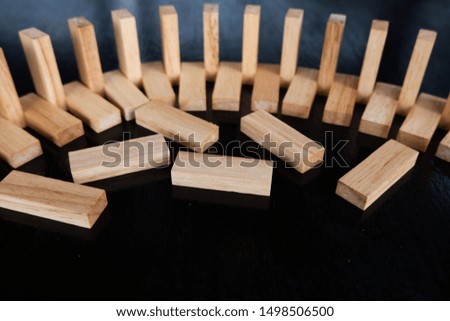 Wood block pile with architecture model with classic black tone background, Concept Risk management and strategy plan, growth business success process and team work.