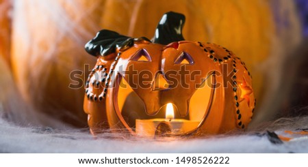 Halloween squash and candle. Spider net. Holiday spooky background still life