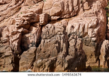 Background of a red cliff at the sea