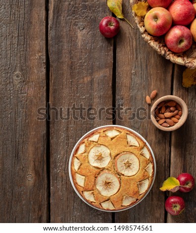 homemade apple pie on a wooden rustic background, top view