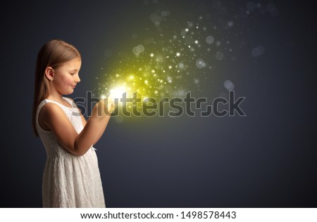 Little cute girl playing on sparkling tablet