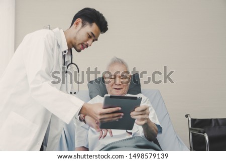 Asian doctor at hospital working holding tablet interviews diagnose with senior man patient. Healthcare and medical people services concept. Surgery operation and medical banner design Royalty-Free Stock Photo #1498579139