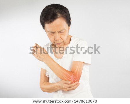 old asian woman feel elbow bones injury