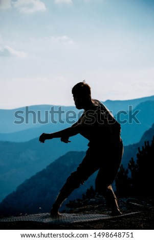 Delighted cheerful handsome positive joyful young silhouette man while dancing
