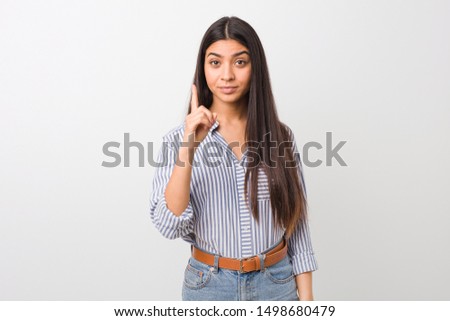 Young pretty arab woman showing number one with finger.