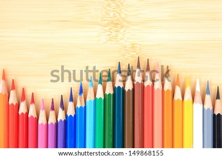 Picture Colour pencils on wood background close up 