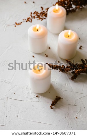 White candles lit on a table