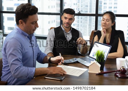business partners sign two contracts at group meeting, businessman Royalty-Free Stock Photo #1498702184