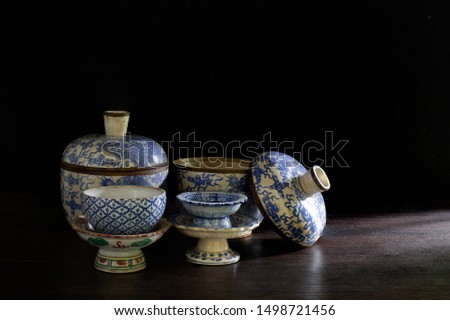 Antique Crockery on dark background and old wooden plate / Still life image selective focus, and space for texts

