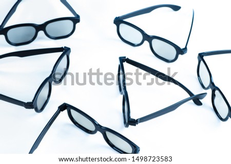 Black-rimmed glasses on a white table. Ophthalmology. Glasses production. Devices for viewing stereo images. Stereo-cinema. Exploded view.