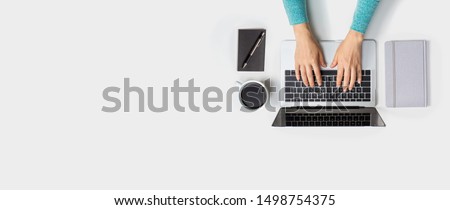 Person using a laptop computer from above Royalty-Free Stock Photo #1498754375