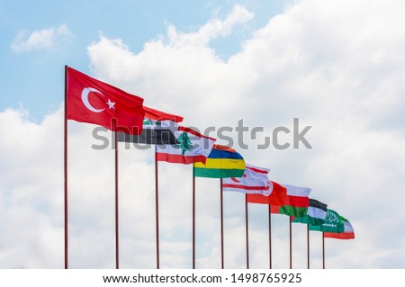 Flags. Waving Flag of 10 Countries with blue sky background.