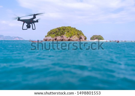 Drone quad copter with high resolution digital camera on the sky mountain and sea side background.