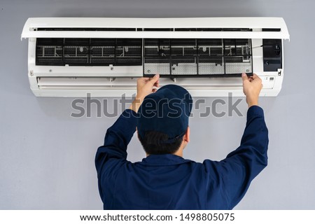 technician service removing air filter of the air conditioner for cleaning Royalty-Free Stock Photo #1498805075