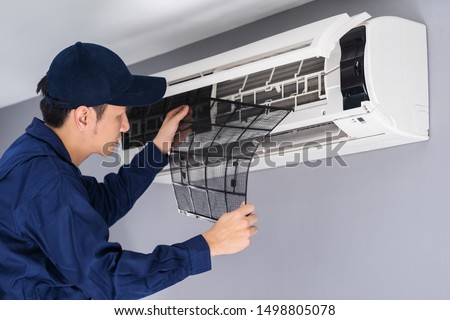 technician service removing air filter of the air conditioner for cleaning Royalty-Free Stock Photo #1498805078