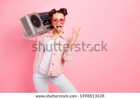Portrait of cheerful disco star girl showing horned sign screaming  wearing white pants trousers heart-shaped eyeglasses eyewear isolated over pink background