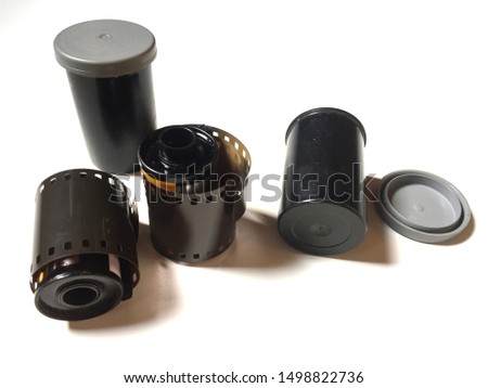 Film roll 35mm color and film tube container isolated white background.