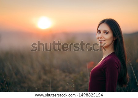 Fashion Portrait of a Happy Woman Admiring Sunset. Girl in nature feeling free and blissful 
