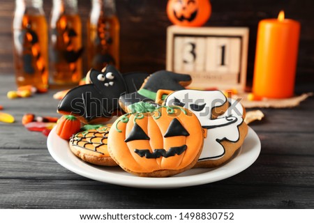 Halloween gingerbread cookies in plate on wooden table