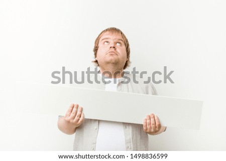 Caucasian crazy blond fat man with a placard