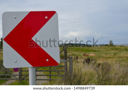 Walk direction sign with red