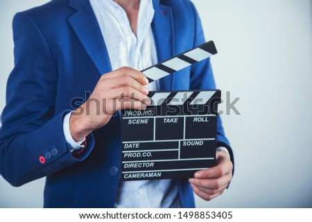 young business man hand movie sign on gray background