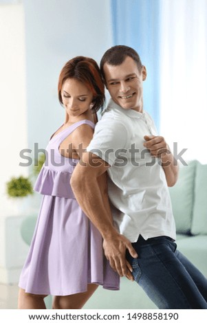 Cute loving couple dancing at home