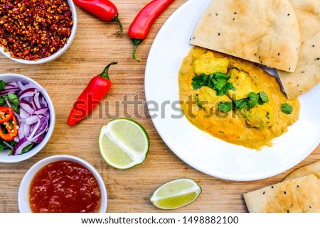 Traditional Indian Chicken Korma Curry Meal With Naan Bread