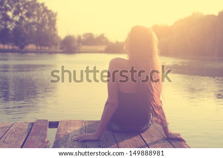 Vintage photo of relaxing young woman in nature Royalty-Free Stock Photo #149888981