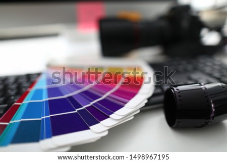 Color palette camera and keyboard are on white table in office. Correct color matching concept