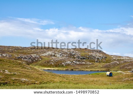 Covered wagon near a blue lake at sunrise. Mizen head pennisula west Cor Ireland.