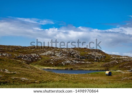 Covered wagon near a blue lake at sunrise. Mizen head pennisula west Cor Ireland.