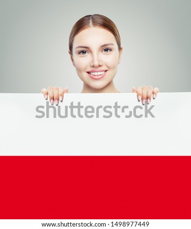 Cute woman showing the Poland flag background. Travel and learn polish language concept Royalty-Free Stock Photo #1498977449