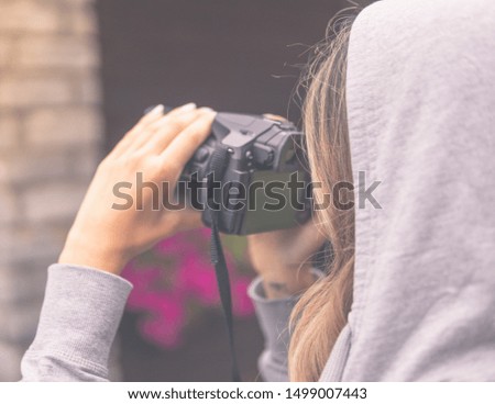 Beautiful woman taking a photo in nature