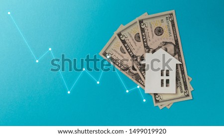 Real estate market concept. Minimalistic paper house on a blue background. Top view. Flat lay. Copy space. Colorful background. New minimal creative concept. Pastel colors